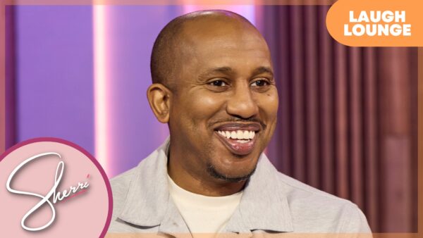 Comedian Chris Redd sits laughing